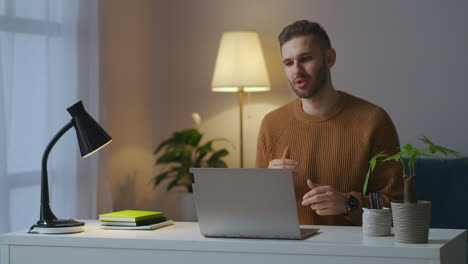 man-is-communicating-with-colleagues-or-partners-by-video-chat-in-laptop-online-communication-and-negotiation-male-portrait-in-room